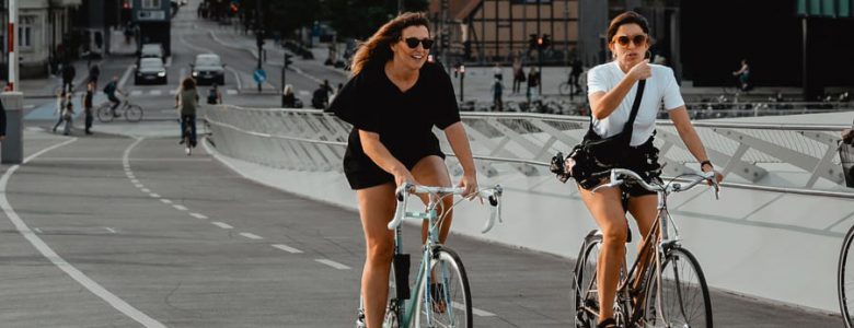Friends bike to work in the city